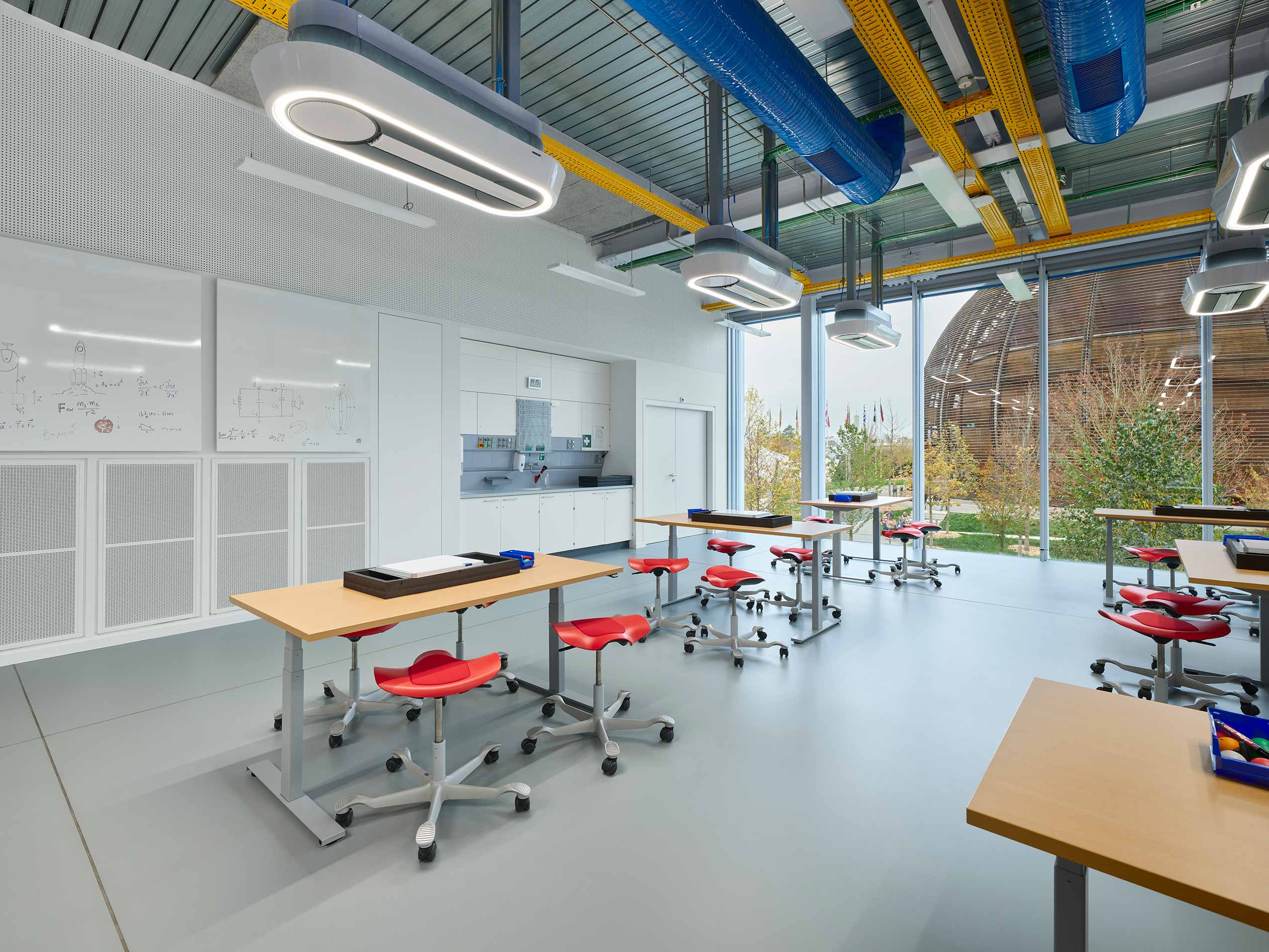 Red HÅG Capisco Puls Stools in childrens workshop lab at CERN Laboratory