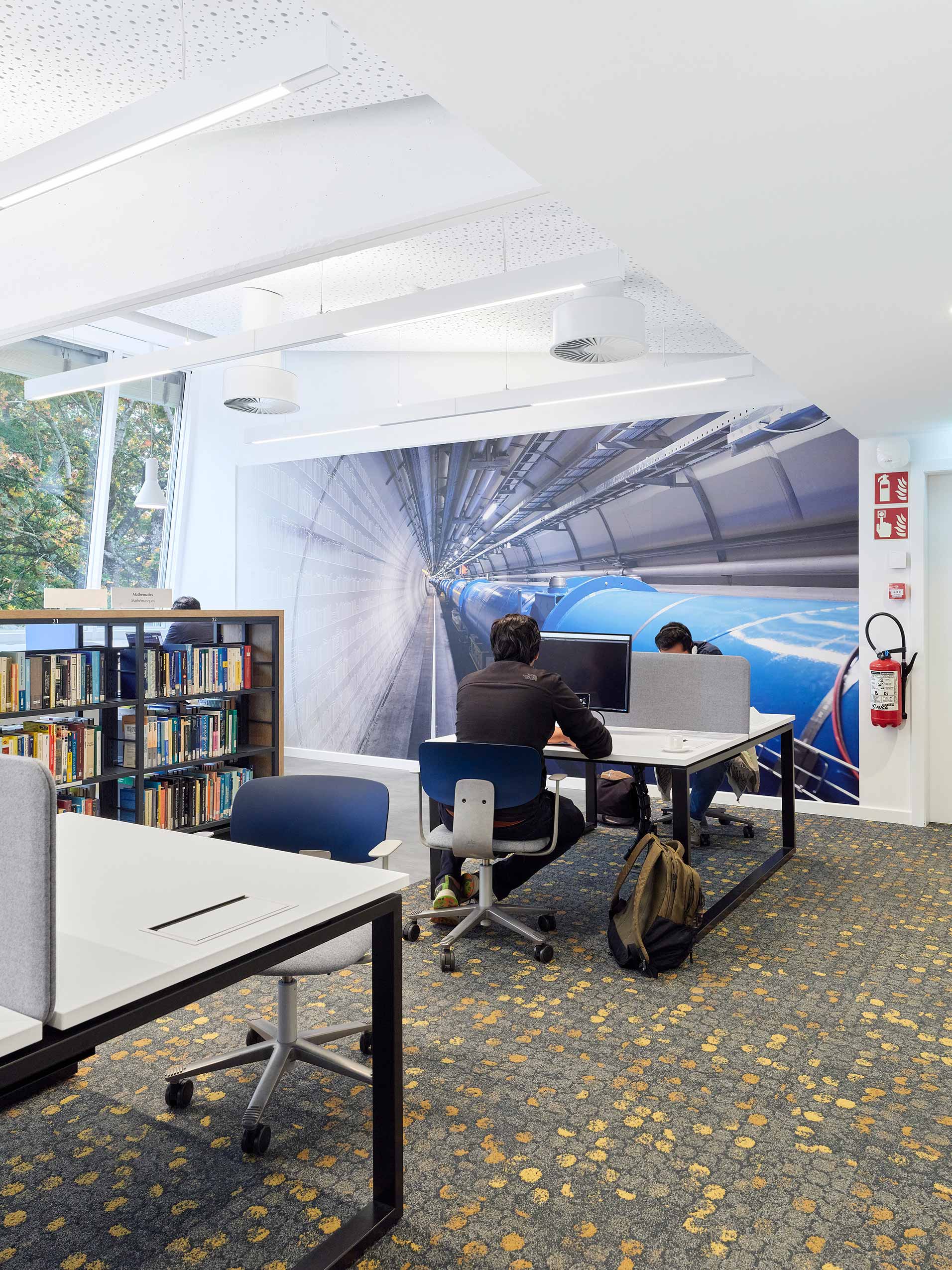 Blue and metal coloured HÅG Tion chairs at workstations in library at CERN Lab